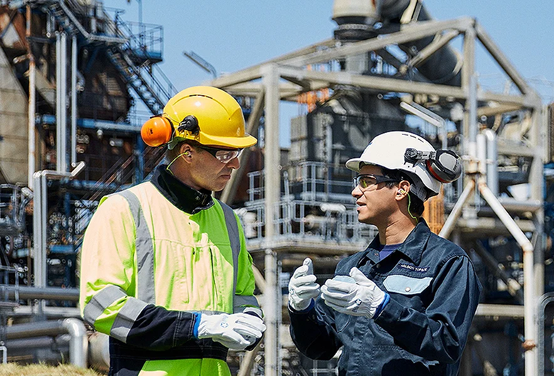 two people at refinery